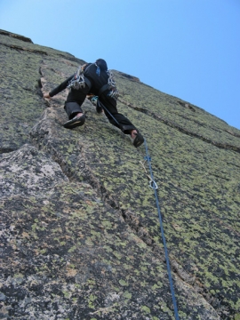 A climber ascends the Finger of Fate